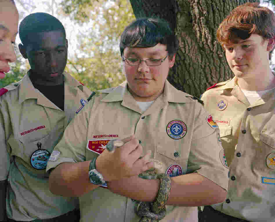 Thomas Haring holding a rat snake at Five Rivers State Park, with (from left) Antonio Holmes, Christian Robinson and Conner McClerry.