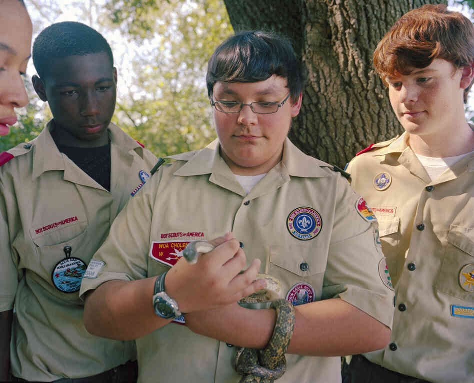 Thomas Haring holding a rat snake at Five Rivers State Park, with (from left) Antonio Holmes, Christian Robinson and Conner McClerry.