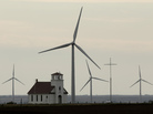 Wind turbines dwarf a church near Wilson, Kan. Although Congress voted to extend a wind energy tax credit, the temporary uncertainty dealt a blow to the industry. Wind turbines dwarf a church near Wilson, Kan. Although Congress voted to extend a wind energy tax credit, the temporary uncertainty dealt a blow to the industry.
