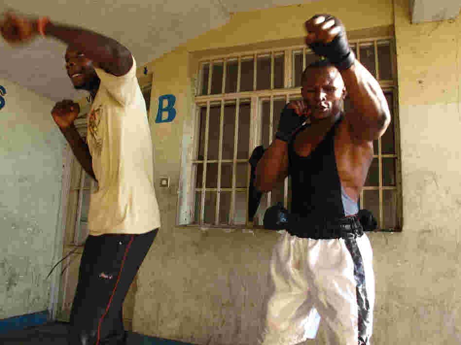 Kibomango trains with former child soldier Fabrice Djef.