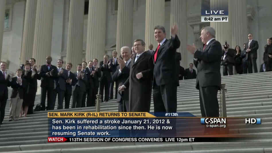 Sen. Mark Kirk, R-Ill., holding a cane. He was helped up the steps of the Capitol by Vice President Biden (behind Kirk) and Sen. Joe Manchin, D-W.Va., (in red tie). Sen. Richard Durbin, D-Ill., is at right.