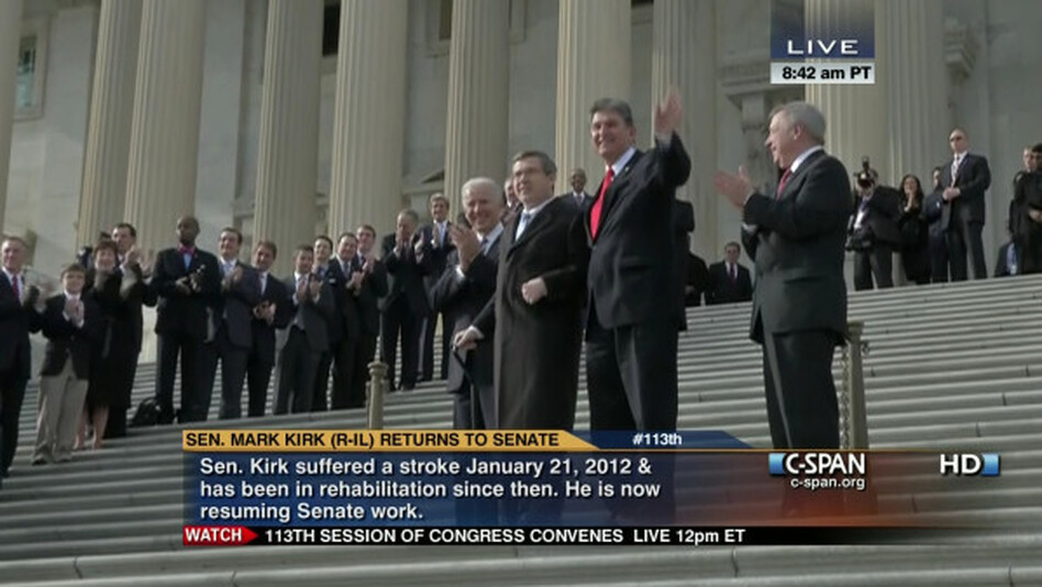 Sen. Mark Kirk, R-Ill., holding a cane. He was helped up the steps of the Capitol by Vice President Biden (behind Kirk) and Sen. Joe Manchin, D-W.Va., (in red tie). Sen. Richard Durbin, D-Ill., is at right.