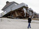 A woman walks past a cabana complex pulled off its foundations by Superstorm Sandy in Sea Bright, N.J., in November. A woman walks past a cabana complex pulled off its foundations by Superstorm Sandy in Sea Bright, N.J., in November.