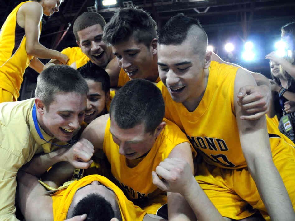 Members of the boys basketball team from Dimond High School in Anchorage, Alaska, celebrate their 2012 state championship victory. Psychological research shows that sports camaraderie improves teenagers' mental health.