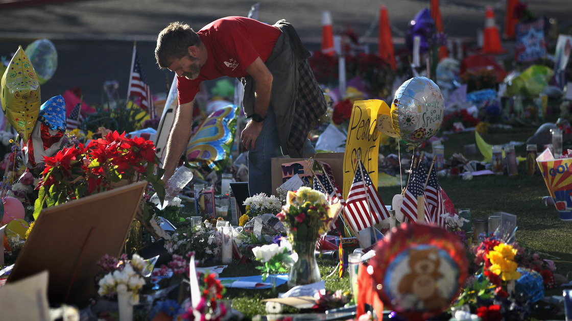 John Underhill waters flowers at a makeshift memorial for shooting victims outside the University Medical Center in Tucson, Ariz., on Jan. 20, 2011. Many of the plants and flowers at area memorials were replanted at a community garden.
