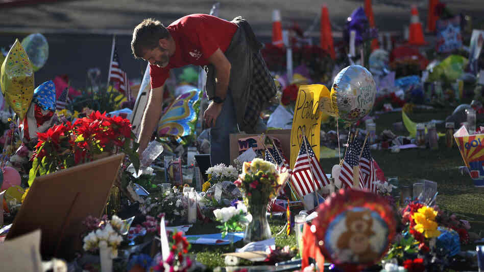 John Underhill waters flowers at a makeshift memorial for shooting victims outside the University Medical Center in Tucson, Ariz., on Jan. 20, 2011. Many of the plants and flowers at area memorials were replanted at a community garden.