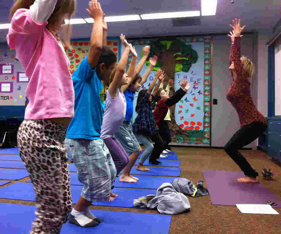 Third-graders at Olivenhain Pioneer Elementary School in Encinitas, Calif., perform chair pose with instructor Kristen McCloskey last month.