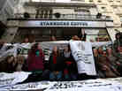Protesters demonstrate outside a Starbucks coffee shop in London last month. Protests were held at  Starbucks throughout the U.K. after it was revealed that the coffee chain had paid almost no corporate taxes for the last three years.