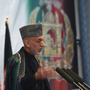Afghan President Hamid Karzai will meet with President Obama and other senior U.S. officials in Washington this week. Many analysts remain skeptical about the prospects for a negotiated peace in Afghanistan. He's shown here speaking in Kabul last month.
