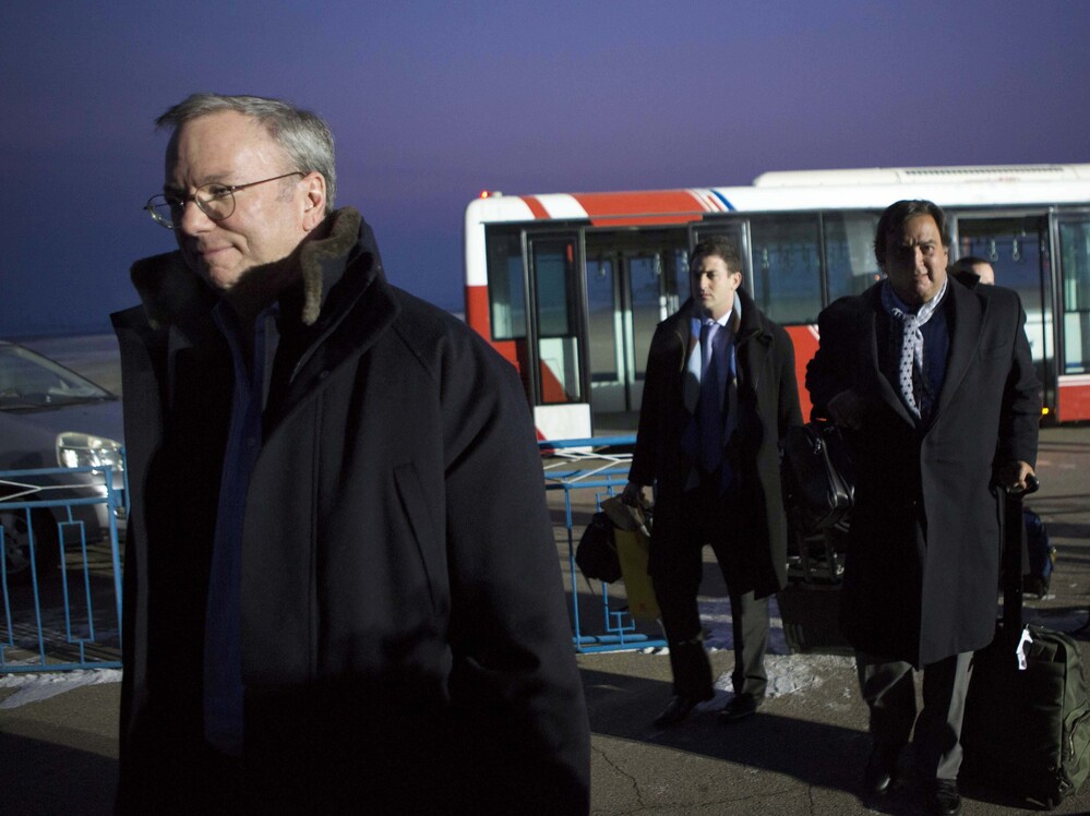 Google's Executive Chairman Eric Schmidt (left) arrives at Pyongyang International Airport on Monday. There is speculation that Schmidt's presence in North Korea could have an upside for Google by positioning Schmidt as the company's global ambassador.