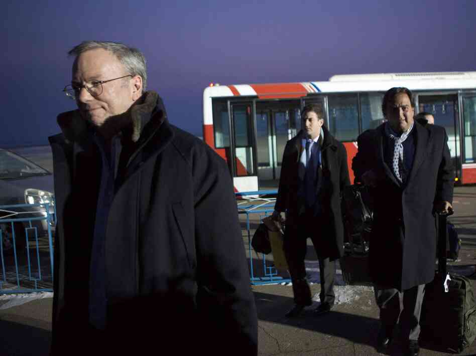 Google's Executive Chairman Eric Schmidt (left) arrives at Pyongyang International Airport on Monday. There is speculation that Schmidt's presence in North Korea could have an upside for Google by positioning Schmidt as the company's global ambassador.