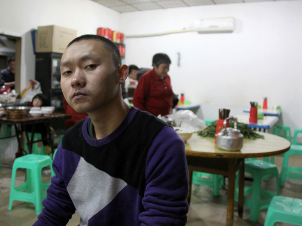 Ren Jianyu poses for a photograph at a restaurant in Chongqing, China, on Nov. 19, 2012, after being freed from a labor camp. The village official was sentenced to a "re-education through labor" camp after he criticized the government.