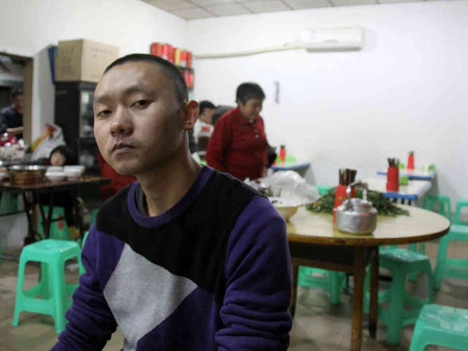 Ren Jianyu poses for a photograph at a restaurant in Chongqing, China, on Nov. 19, 2012, after being freed from a labor camp. The village official was sentenced to a "re-education through labor" camp after he criticized the government.