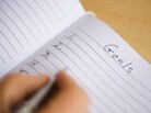 Close up of man's hand writing New Years resolution in notebook, studio shot --- Image by Tetra Images/Corbis Close up of man's hand writing New Years resolution in notebook, studio shot --- Image by Tetra Images/Corbis