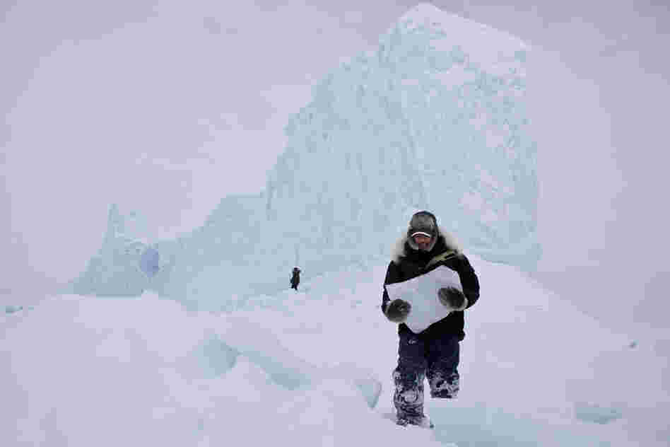 "Chipping ice off an iceberg is a common way for the Inuit community to retrieve fresh drinking water while on the land. During a weekend-long hunting trip, we came upon this majestic iceberg frozen in place. It was a perfect opportunity to grab enough ice and drinking water for the remainder of the trip.'