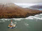 The 266-feet-wide Kulluk oil rig, seen here as it sat aground last Thursday, is being towed 30 miles to the north.
