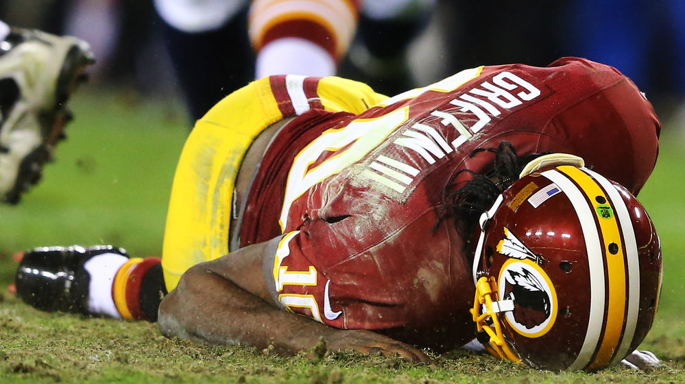 Washington Redskins quarterback Robert Griffin III reinjured his right knee during Sunday's playoff game against the Seattle Seahawks. Washington lost 24-14. Washington Redskins quarterback Robert Griffin III reinjured his right knee during Sunday's playoff game against the Seattle Seahawks. Washington lost 24-14.