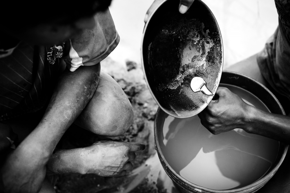 After 12 hours of dredging and another hour separating the gold particles from the sediment, a young miner pours the gold amalgam -- a mix of liquid mercury and gold particles -- into a container, which will then be taken to a gold shop where the mercury is burned off, leaving raw gold.