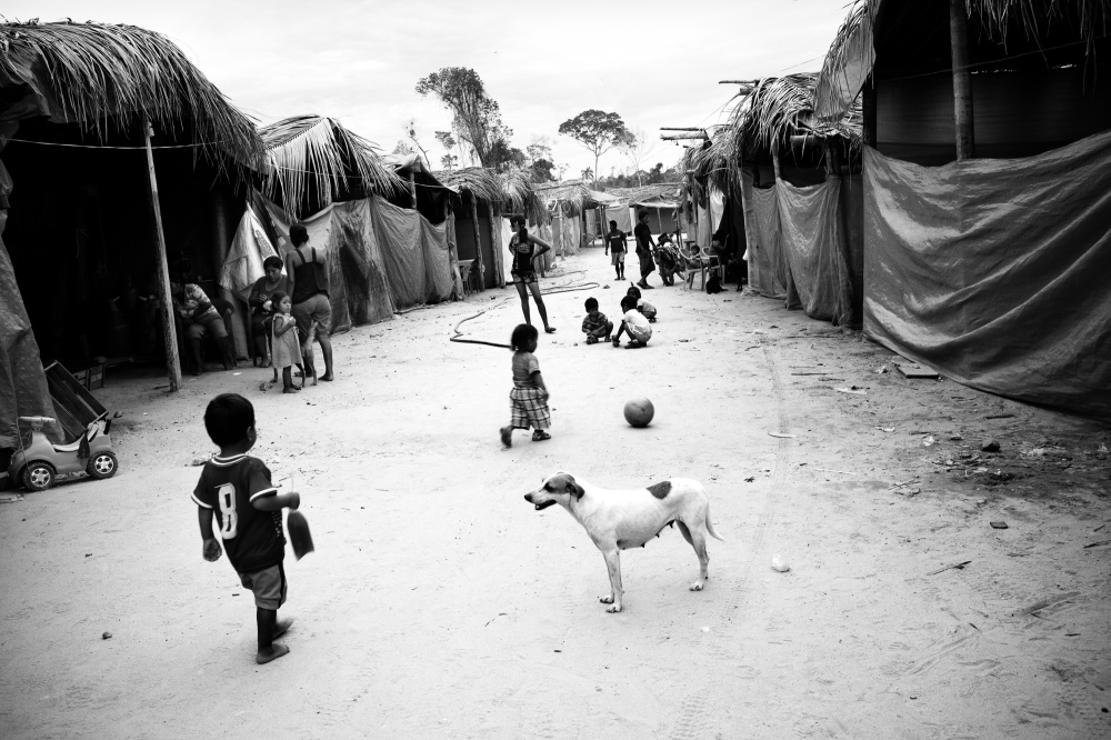 Children play in a mining camp along the Interoceanic Highway. Though most miners are single men from the Andean highlands (and increasingly from Brazil), some also bring their families to these temporary mining camps. Though the camps will often have restaurants, stores, repair shops and internet cafes, as well as bars and prostitutes, they don't have schools, regular health care or clean water.