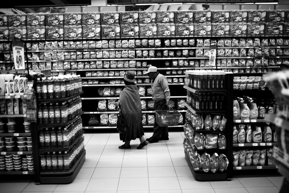 An older indigenous couple shop at Plaza Vea, the first large grocery and department store in Juliaca, Peru.
