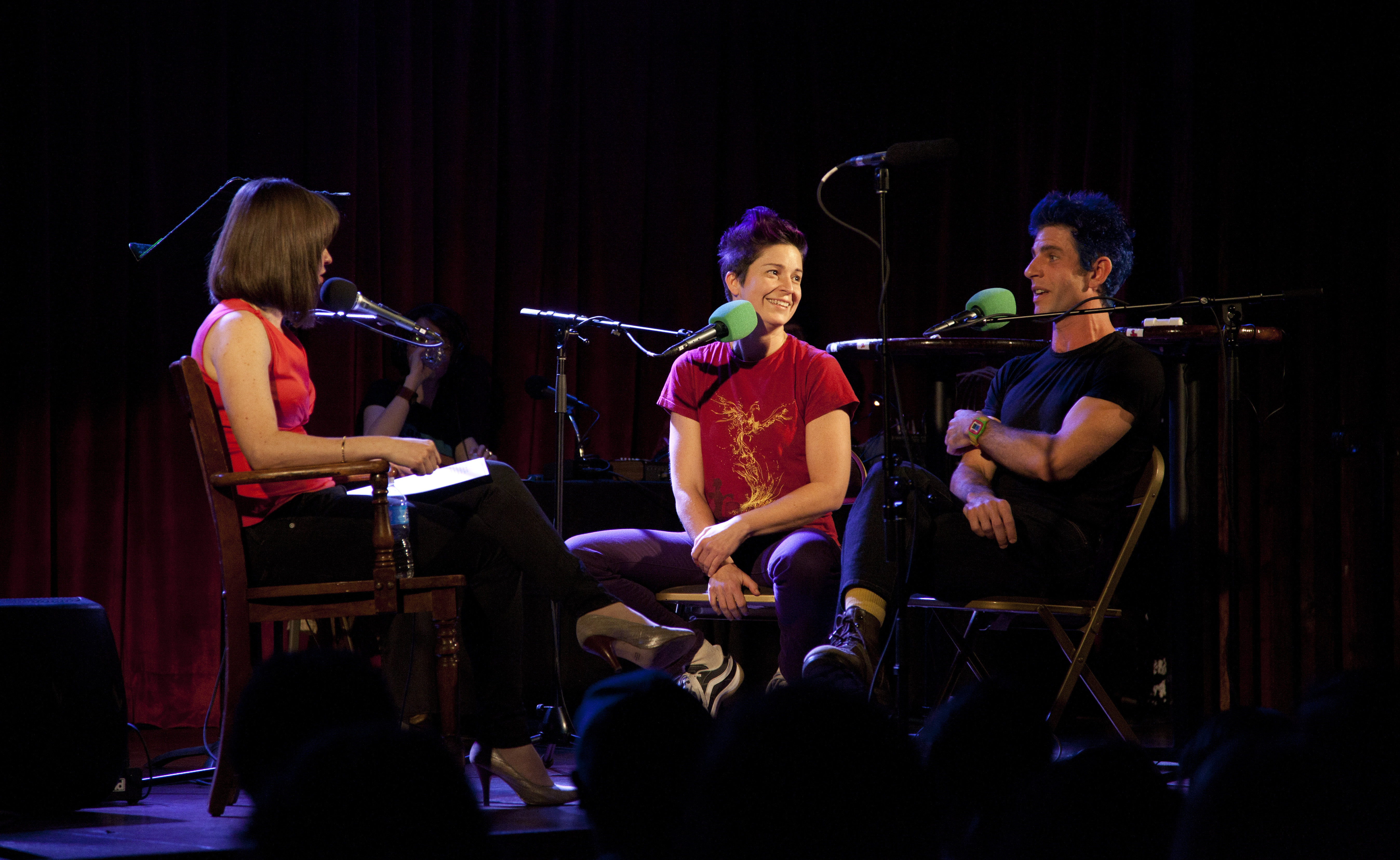Host Ophira Eisenberg (left) interviews Christina Gelsone and Seth Bloom, a.k.a. Big Apple Circus' Acrobuffos, during a taping of Ask Me Another in Brooklyn, NY.