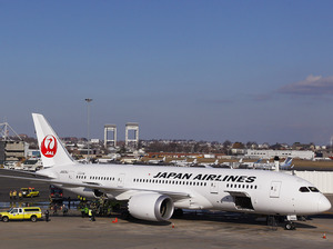 A Japan Airlines Boeing 787 Dreamliner jet aircraft is surrounded by emergency vehicles while parked at a Terminal E gate at Logan International Airport in Boston on Monday. A small electrical fire filled the cabin of the JAL aircraft with smoke about 15 minutes after it landed in Boston.