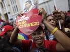 A supporter of Venezuela's President Hugo Chavez holds a heart-shaped sign that reads in Spanish "I vote for Chavez!" and a picture of Chavez outside the National Assembly in Caracas over the weekend. On Thursday, Chavez is scheduled to be sworn in for a fourth term. Government officials are suggesting the ceremony could be delayed as the president recovers from cancer surgery in Cuba. A supporter of Venezuela's President Hugo Chavez holds a heart-shaped sign that reads in Spanish "I vote for Chavez!" and a picture of Chavez outside the National Assembly in Caracas over the weekend. On Thursday, Chavez is scheduled to be sworn in for a fourth term. Government officials are suggesting the ceremony could be delayed as the president recovers from cancer surgery in Cuba.
