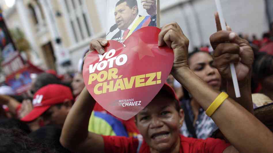 A supporter of Venezuela's President Hugo Chavez holds a heart-shaped sign that reads in Spanish "I vote for Chavez!" and a picture of Chavez outside the National Assembly in Caracas over the weekend. On Thursday, Chavez is scheduled to be sworn in for a fourth term. Government officials are suggesting the ceremony could be delayed as the president recovers from cancer surgery in Cuba.