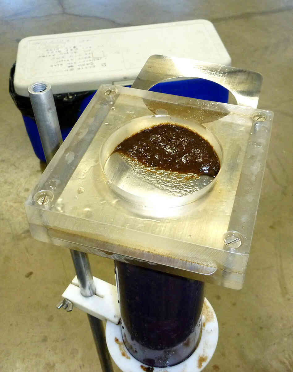 Layers of lake sediment are removed at intervals from a core. In a laboratory, contaminants and biological remains are analyzed from select sediment layers to understand lake history and reconstruct environmental changes that often predate periods of direct monitoring.
