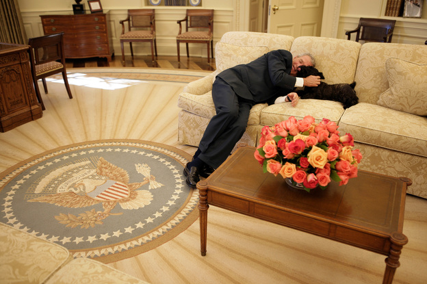 President George W. Bush takes a breather on the couch with his dog Miss Beazley.