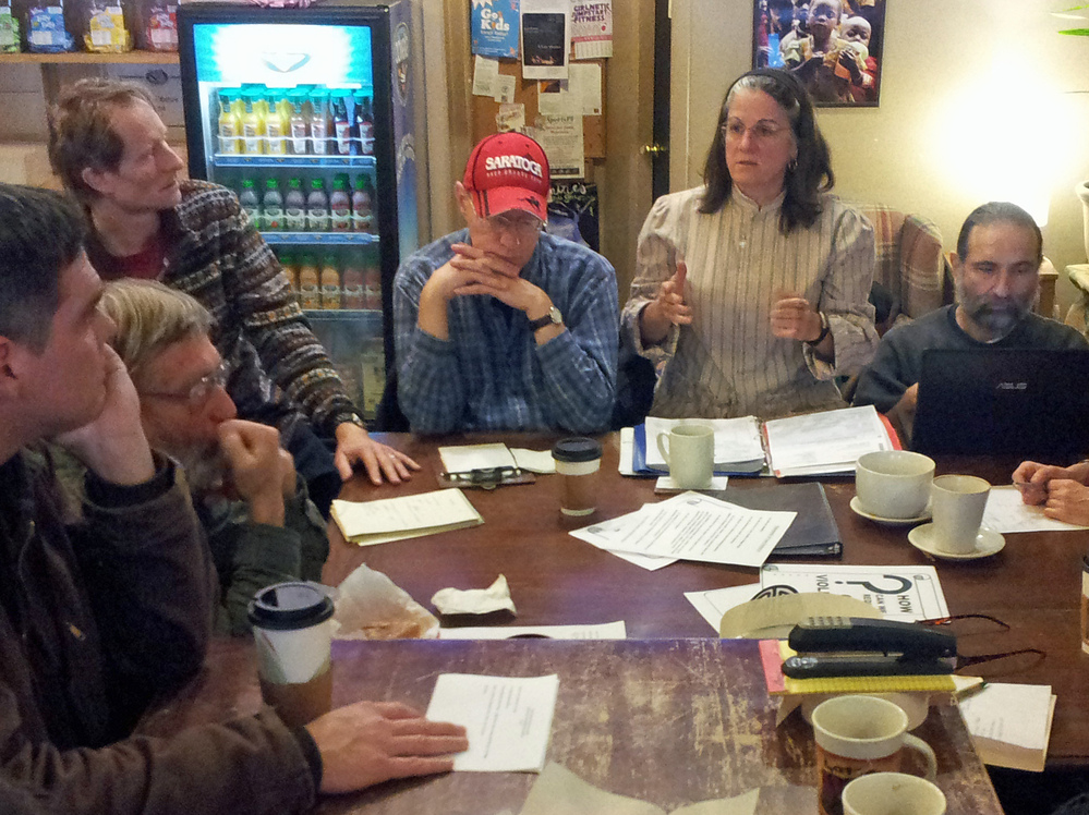 Members of the Saratoga Peace Alliance discuss plans for a street action they plan to stage at the city's upcoming gun show. Members of the Saratoga Peace Alliance discuss plans for a street action they plan to stage at the city's upcoming gun show.