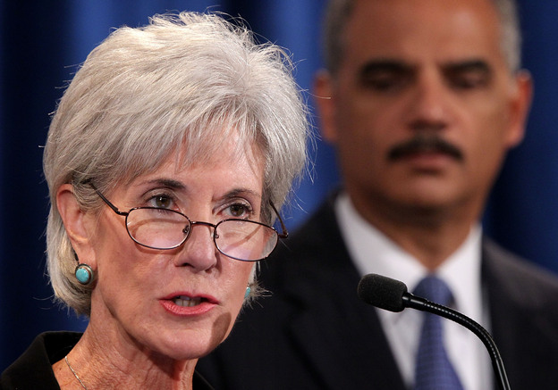 Health and Human Services Secretary Kathleen Sebelius speaks as Attorney General Eric Holder listens during a news conference last October. The two plan to remain in their current jobs as President Obama's second term begins.