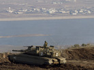 An Israeli tank in the Golan Heights overlooks the Syrian village of Bariqa in November. Israel, which captured the Golan Heights from Syria in 1967, says it's building a fence there because it's concerned about spillover from the Syrian war. An Israeli tank in the Golan Heights overlooks the Syrian village of Bariqa in November. Israel, which captured the Golan Heights from Syria in 1967, says it's building a fence there because it's concerned about spillover from the Syrian war.