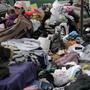 Volunteers sort through piles of donated clothes for Superstorm Sandy victims at an impromptu Staten Island aid station in November. Relief groups are still trying to figure out what to do with donated clothes people sent to New York and New Jersey in Sandy's aftermath.