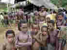 Chances are they already speak more languages than you: children from Papua New Guinea's Andai tribe of hunter-gatherers wait for their parents to vote in the village of Kaiam. Over 800 languages are spoken in PNG, a country of about six million people.