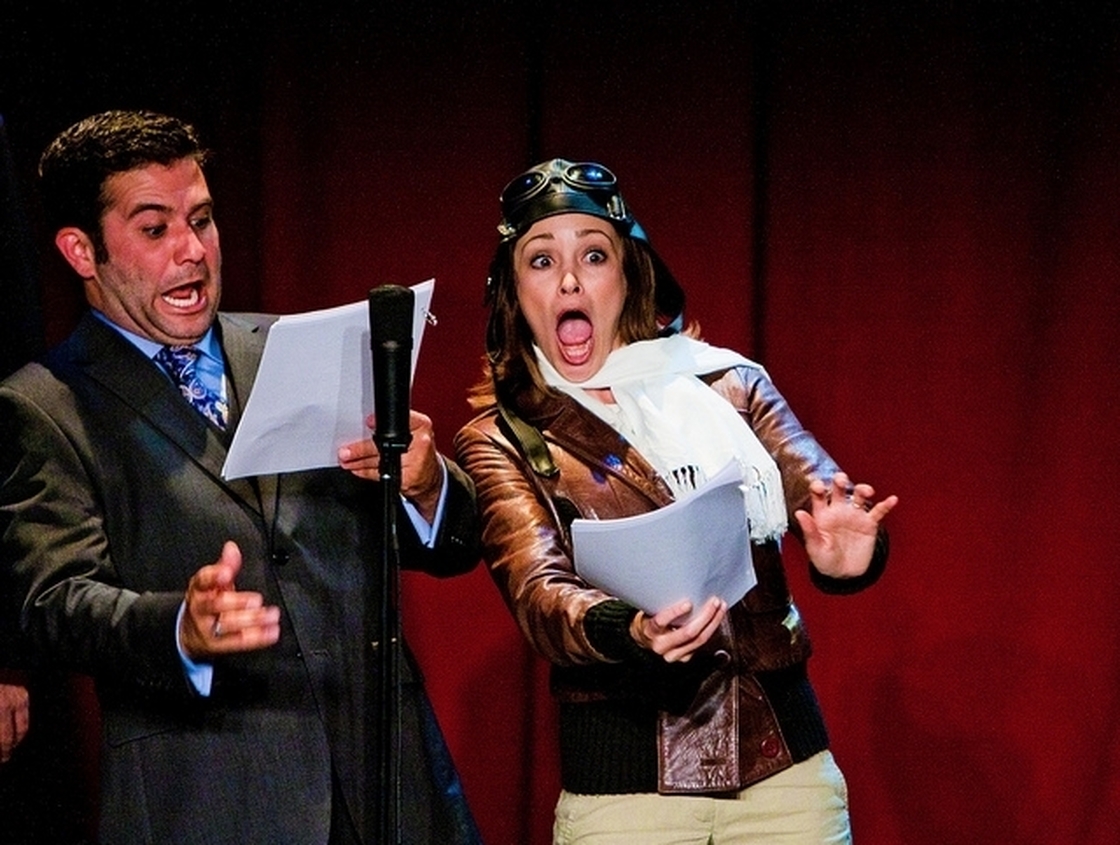 Mark Gagliardi and Autumn Reeser, as aviator Amelia Earhart, perform in The Thrilling Adventure Hour. Actors dress up and read scripts onstage in front of a live nightclub audience.