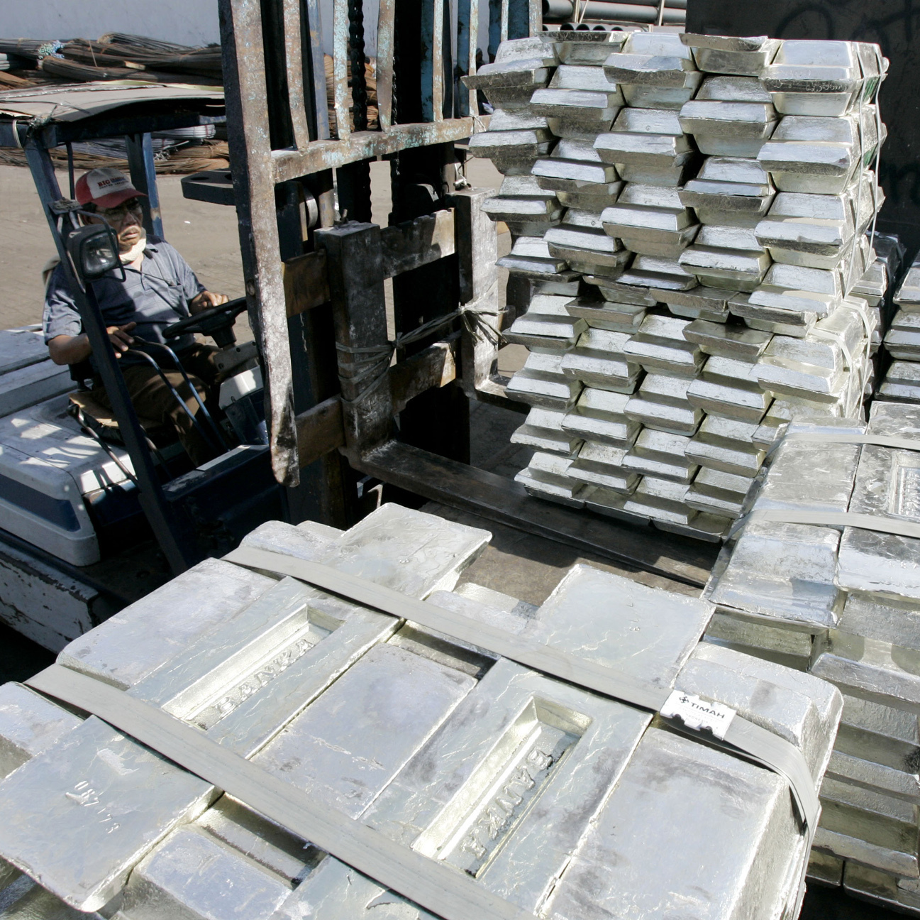 This port worker in Indonesia is moving tin ingots around a dock. But he probably wishes these big bars were made of platinum instead. Then, they'd be worth about $26,000 per pound.