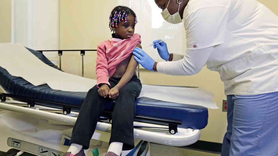 Four-year-old Gabriella Diaz gets a flu shot at the Whittier Street Health Center in Boston, Mass., on Wednesday, the same day the city declared a public health emergency. Four-year-old Gabriella Diaz gets a flu shot at the Whittier Street Health Center in Boston, Mass., on Wednesday, the same day the city declared a public health emergency.