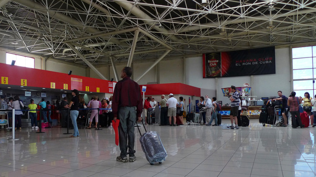 A traveler stands at the check-in lobby at Havana's Jose Marti International Airport last year. On Jan. 14, Cuba scraps a much-reviled, decades-old exit permit requirement, easing most Cubans' exit and return.