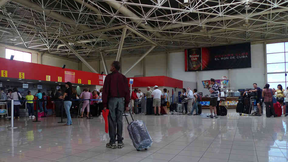 A traveler stands at the check-in lobby at Havana's Jose Marti International Airport last year. On Jan. 14, Cuba scraps a much-reviled, decades-old exit permit requirement, easing most Cubans' exit and return.