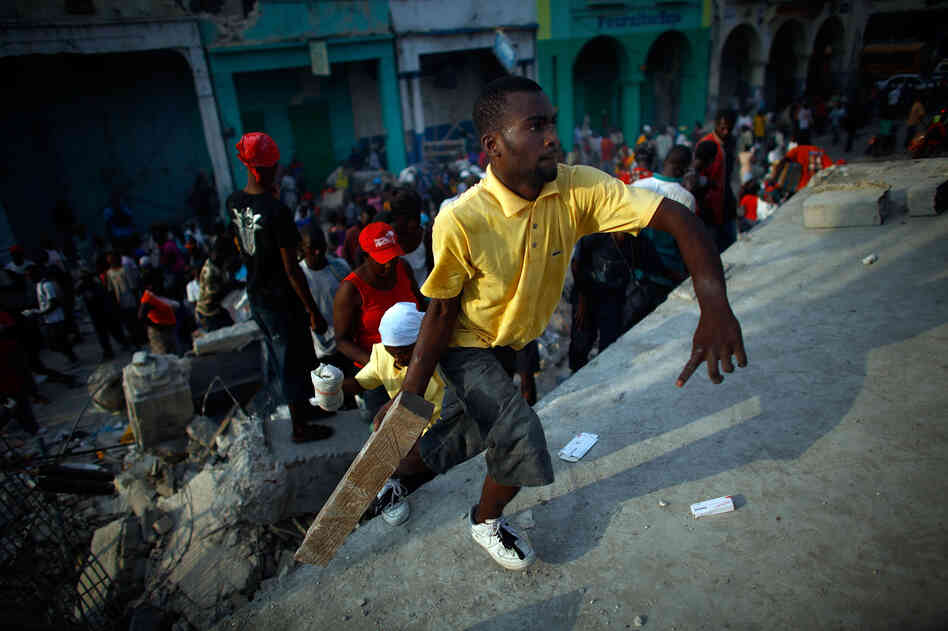 Looters on the roof of a collapsed supermarket in Port-au-Prince, Haiti, Jan. 20, 2010.