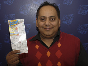 Urooj Khan poses with a winning lottery ticket. He died after winning a $1 million lottery in Chicago. Forensic pathologists at first said Khan died of natural causes, but that ruling was later changed to death by cyanide poisoning.