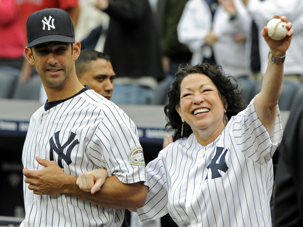 Sotomayor is escorted onto the field by New York Yankees catcher Jorge Posada to throw out the ceremonial first pitch before the New York Yankees game against the Boston Red Sox on Sept. 26, 2009 at Yankee Stadium in New York.