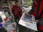 A man buys the latest edition of Southern Weekly at a newsstand near the newspaper's headquarters in Guangzhou, Guangdong province, China, on Thursday. The staff at the influential weekly rebelled to protest censorship by government officials; the newspaper was published Thursday after a compromise that called for relaxing some intrusive controls. A man buys the latest edition of Southern Weekly at a newsstand near the newspaper's headquarters in Guangzhou, Guangdong province, China, on Thursday. The staff at the influential weekly rebelled to protest censorship by government officials; the newspaper was published Thursday after a compromise that called for relaxing some intrusive controls.