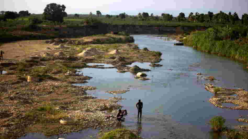 Men bathe in a branch of the Artibonite River outside Saint-Marc. Haiti's cholera outbreak in 2010 began about 60 miles upstream from here. Men bathe in a branch of the Artibonite River outside Saint-Marc. Haiti's cholera outbreak in 2010 began about 60 miles upstream from here.