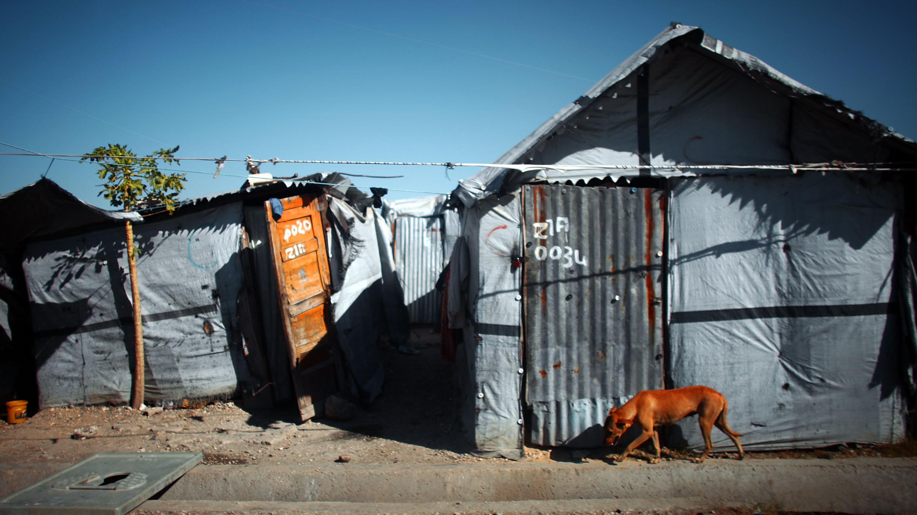 The La Piste camp in Port-au-Prince held 50,000 residents at one point. Some residents have left, but the camp is still overcrowded. Residents say they have few options for work or even hope to leave.