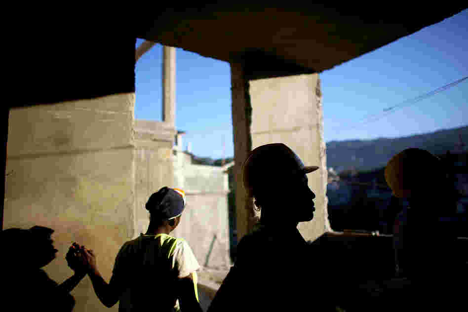Workers finish the cement walls on a multilevel building in the hills above Port-au-Prince near Petionville. They plan to finish the 18-unit housing facility in 2013.