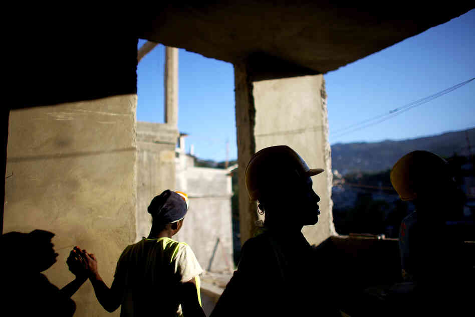 Workers finish the cement walls on a multilevel building in the hills above Port-au-Prince near Petionville. They plan to finish the 18-unit housing facility in 2013.