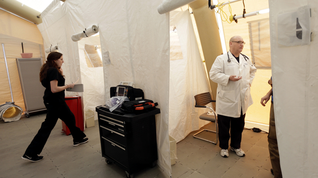 Registered nurse Michelle Newbury and physician assistant Scott Fillman see patients Thursday in a tent set up for people with flu symptoms, just outside the emergency entrance at the Lehigh Valley Hospital in Allentown, Pa.