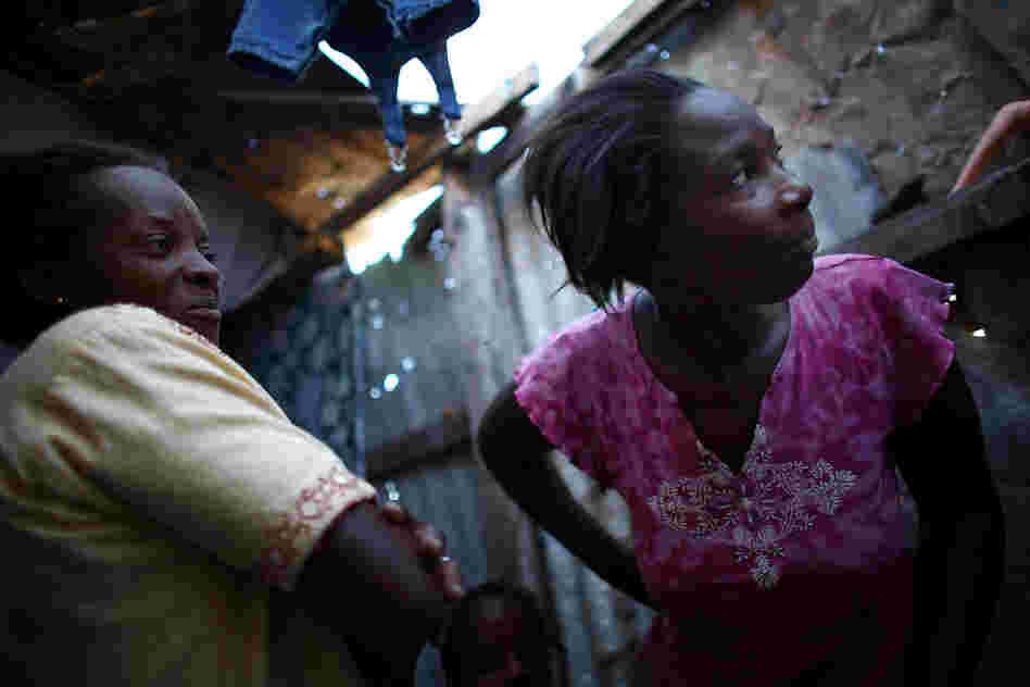 Bibeta Louissaint (left) and Beatrice Rochelain are neighbors in the Fort National neighborhood in Port-au-Prince. Many people who received cash and subsidies to move out of the camps have returned to the area.